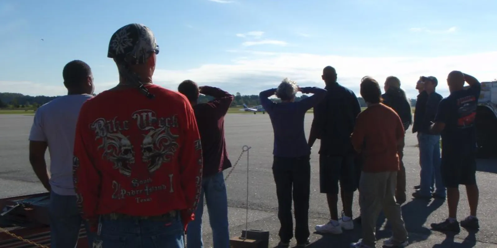 a group of people standing on a runway