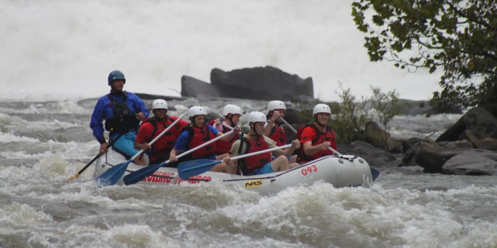 a group of people riding on a raft in a body of water