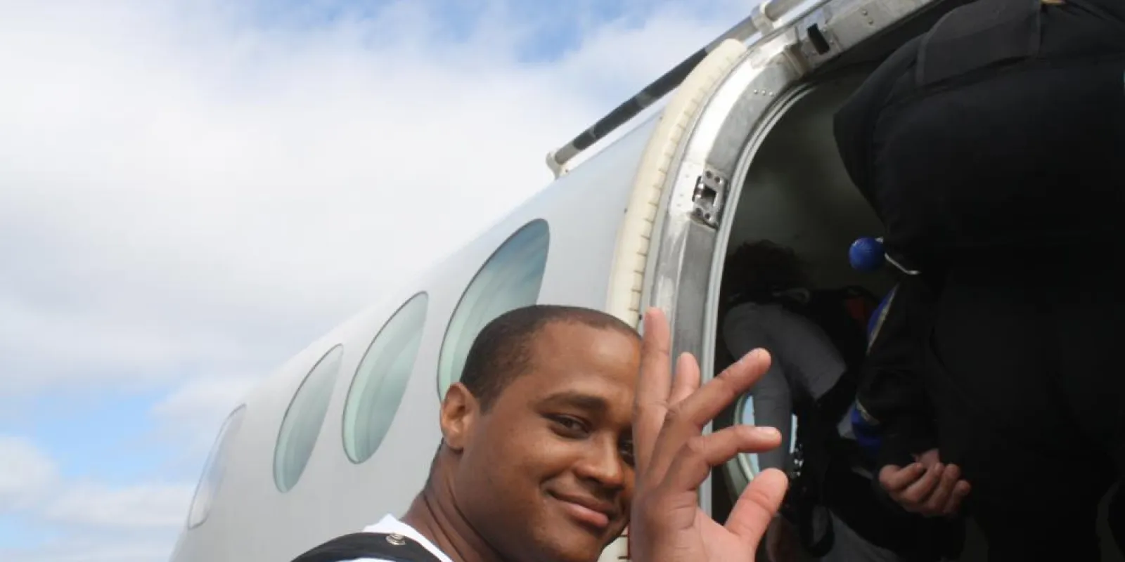 a man waving at the camera