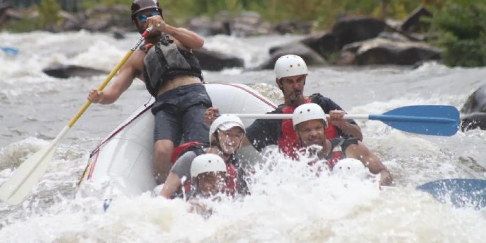 a group of people riding on a raft in a body of water