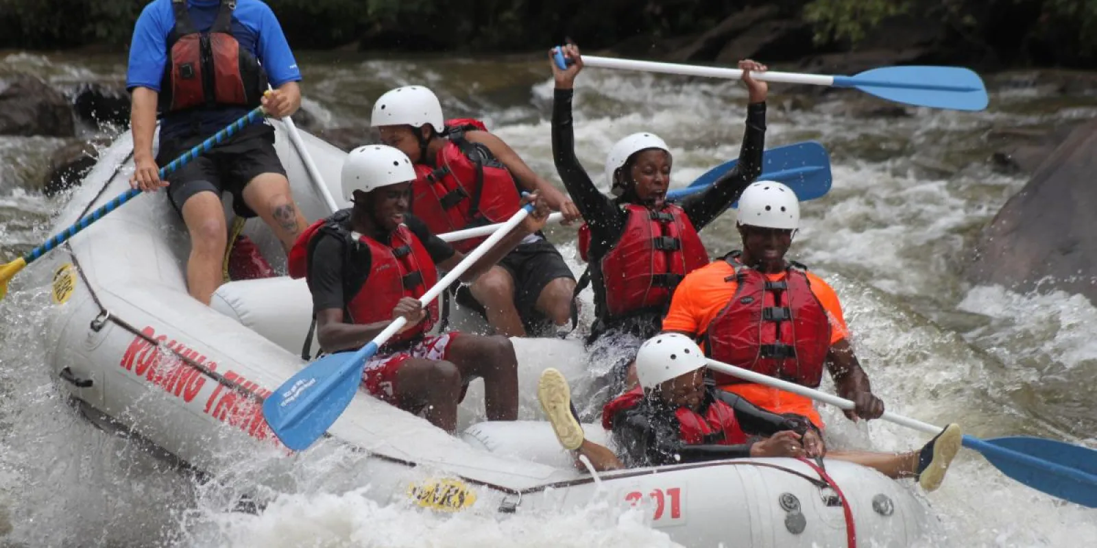 a group of people riding on a raft