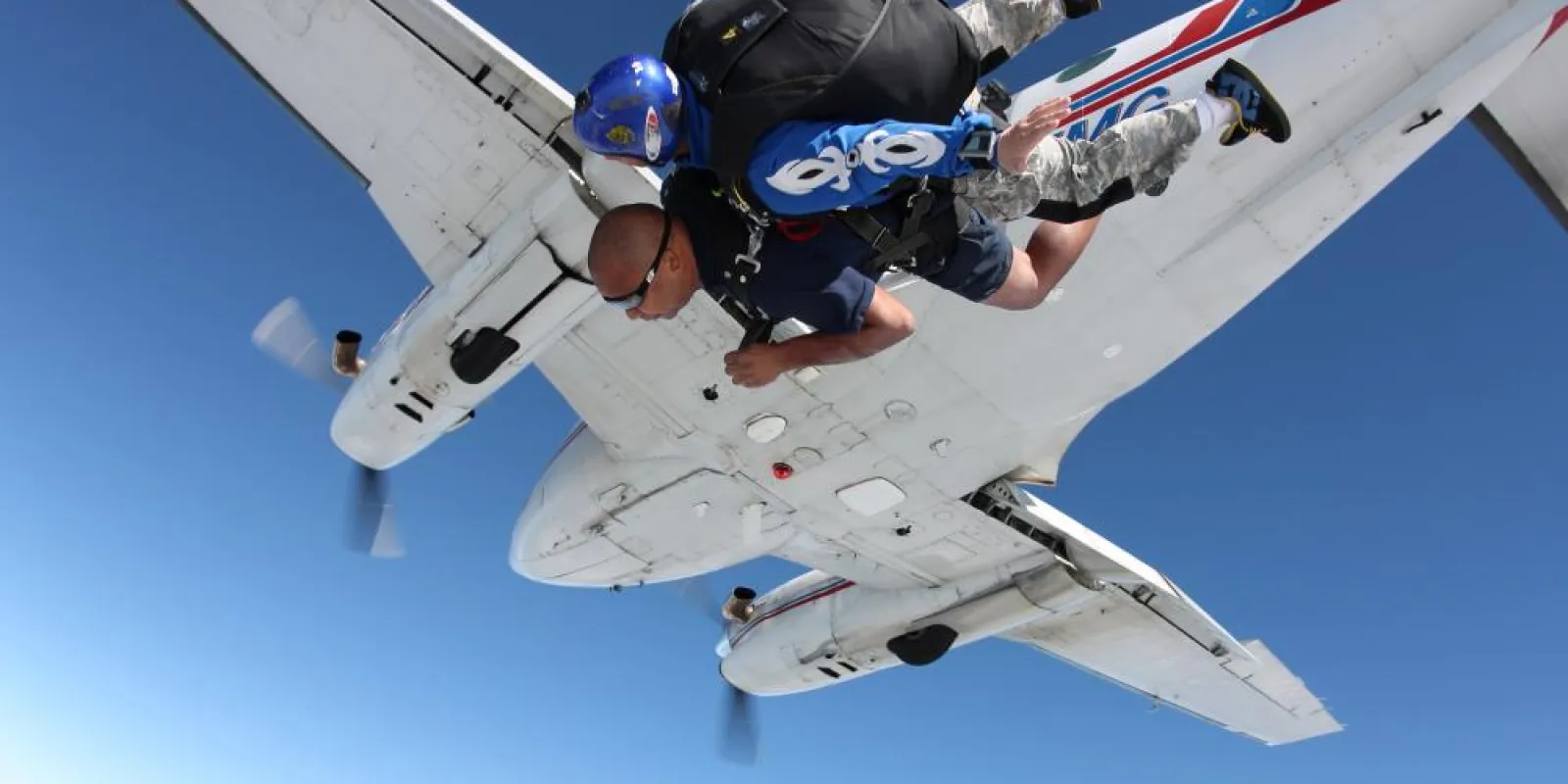two people jumping out of a plane