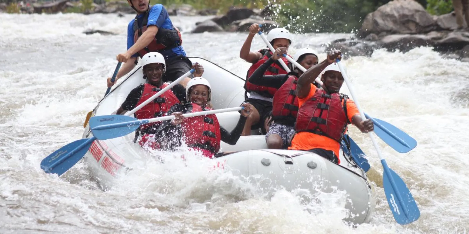 a group of people riding on the rapids