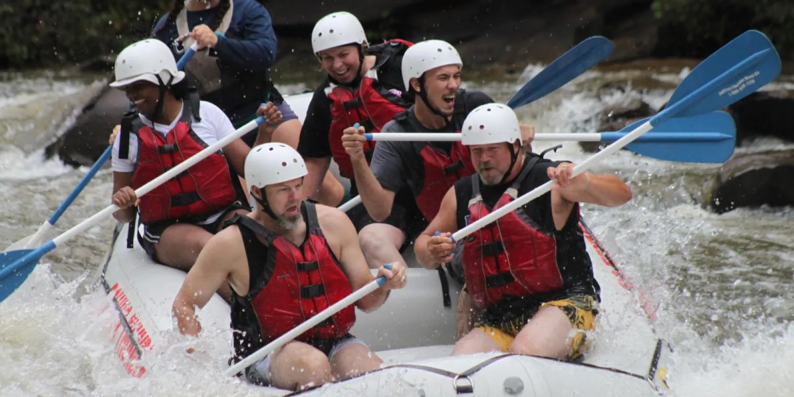 a group of people riding on the rapids