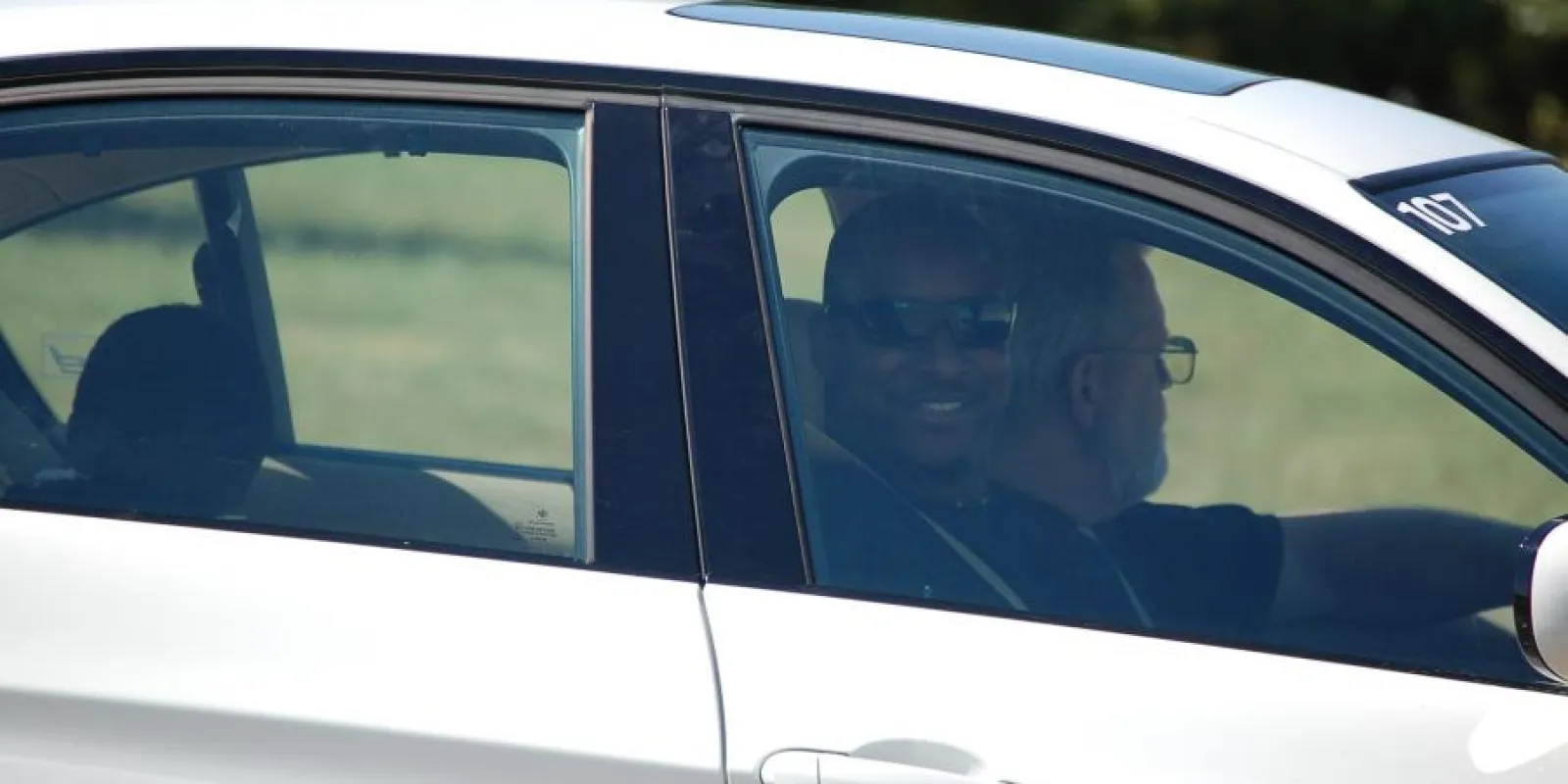 Eric in a car smiling at the camera