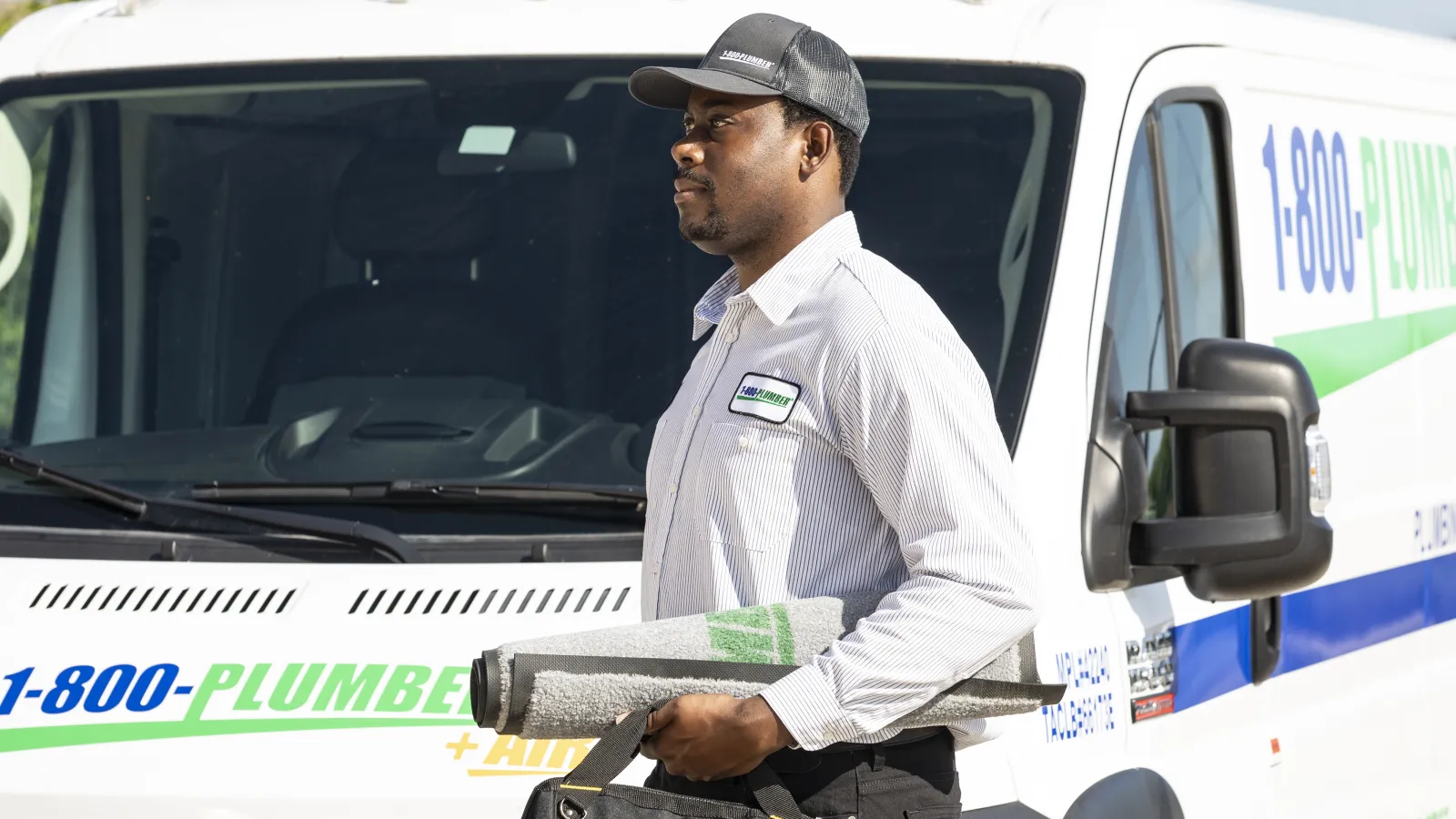 a man standing in front of plumbing van