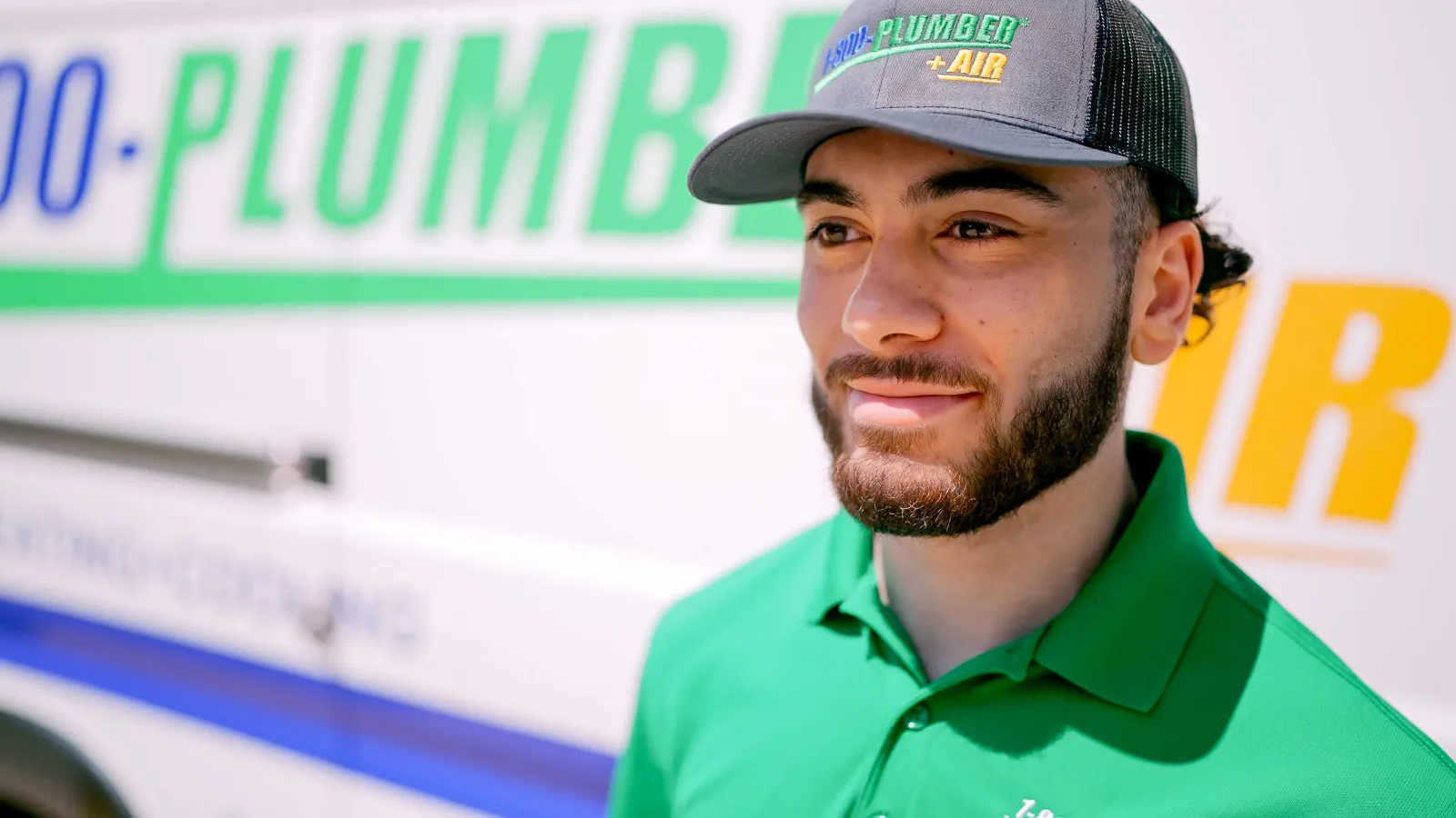 a man walking in front of plumbing van