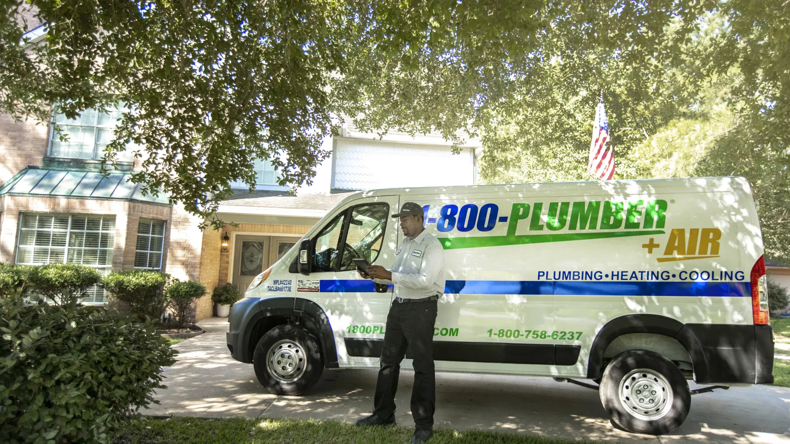 a man standing in front of plumbing van