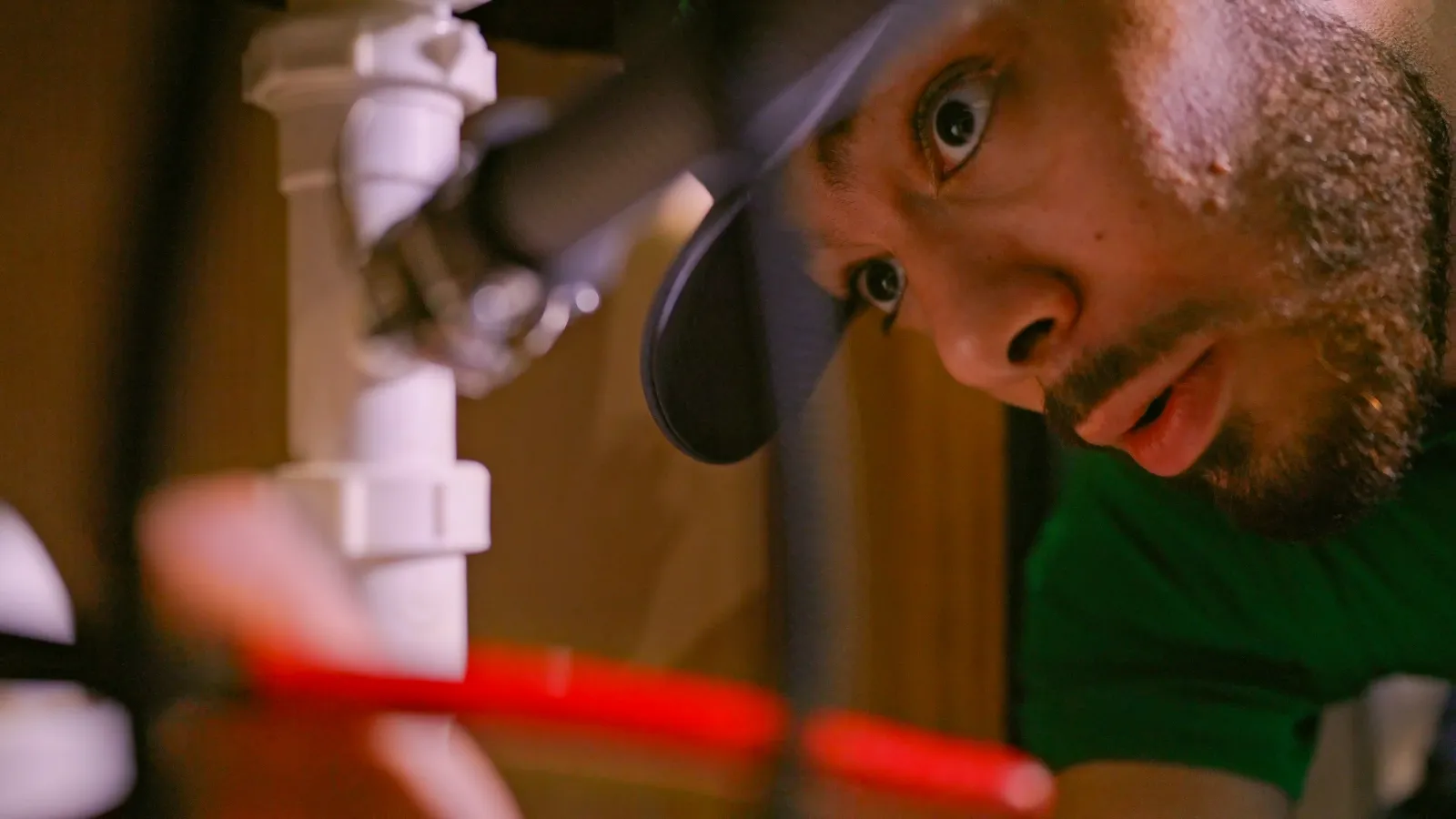 a technician working on plumbing