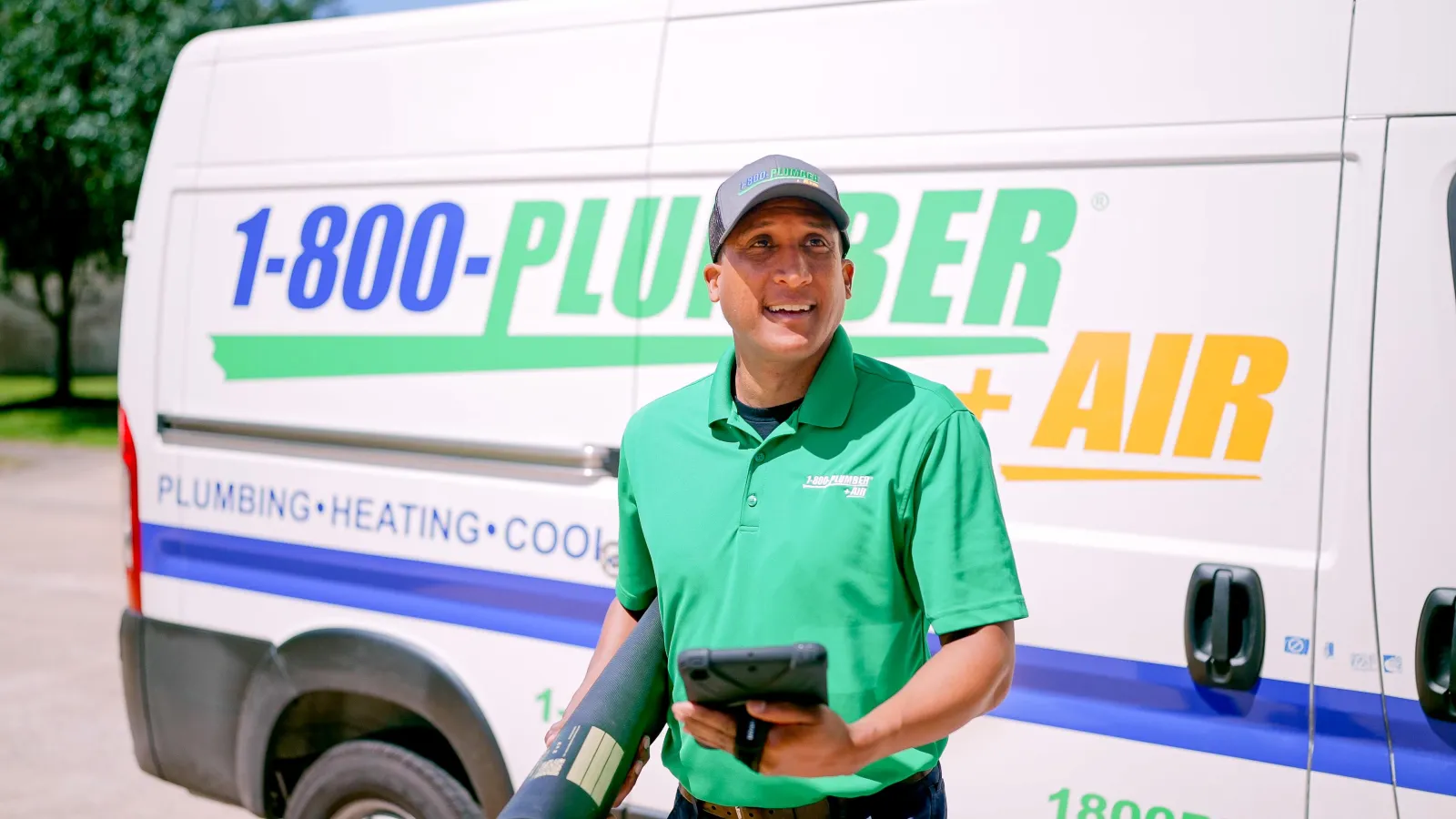 A 1-800-Plumber +Air of Pearland heating technician and a van