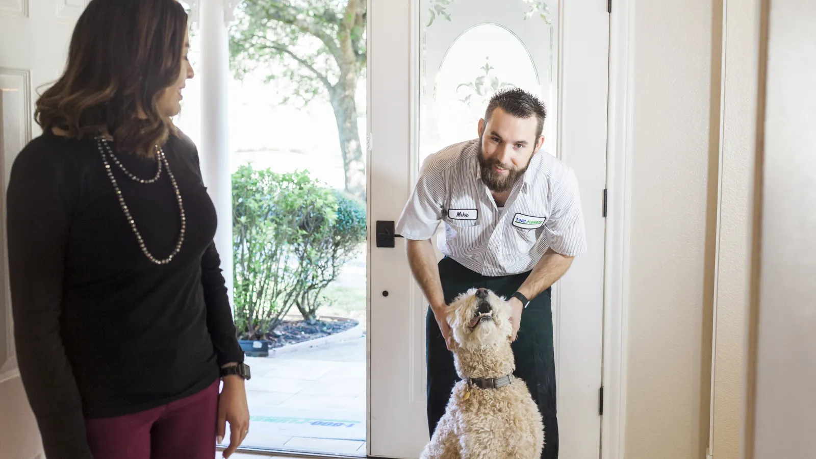 a man petting a dog