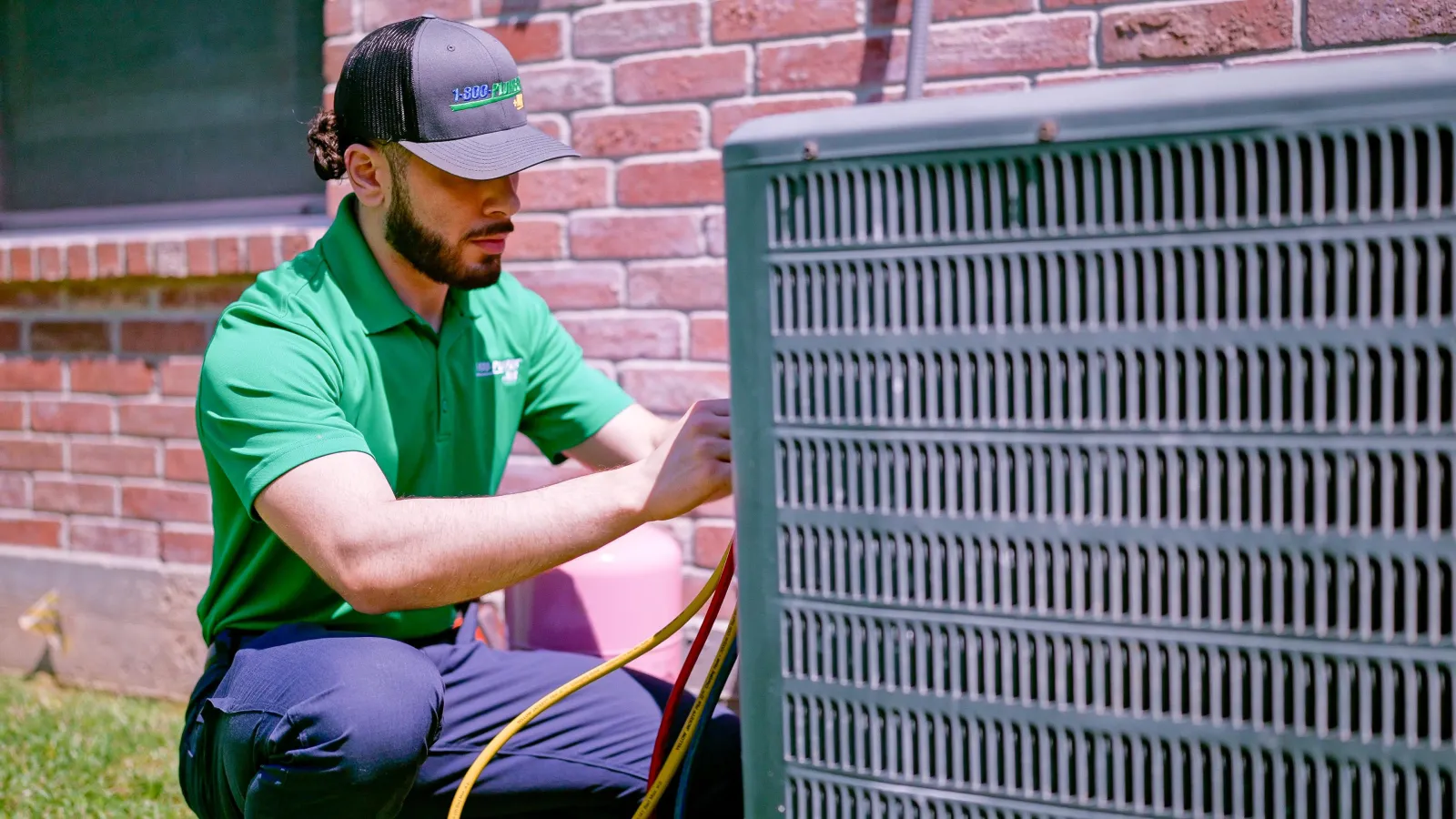 A Raleigh AC technician repairs an outdoor air conditioning unit
