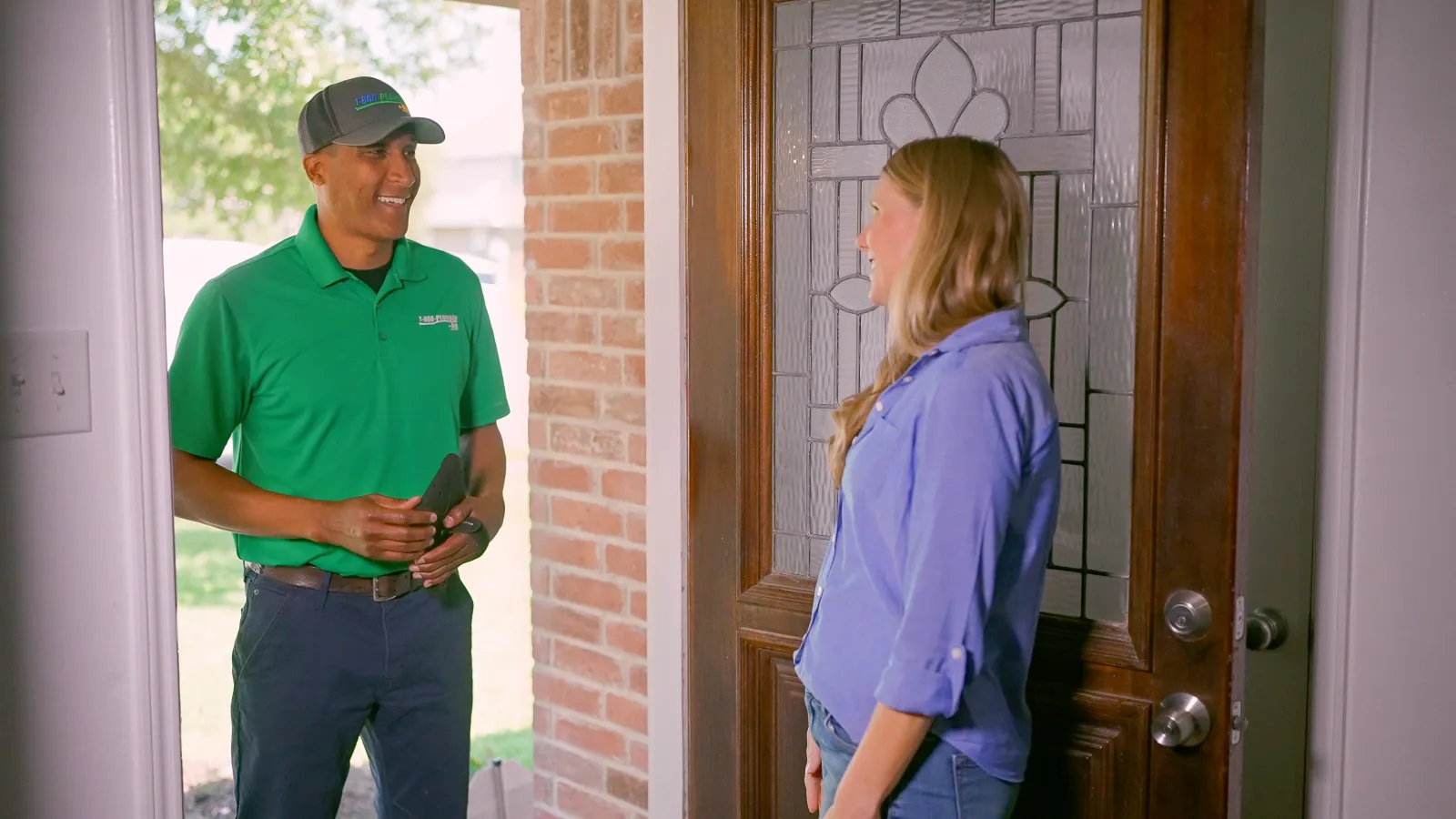 A Katy plumbing technician greets a homeowner