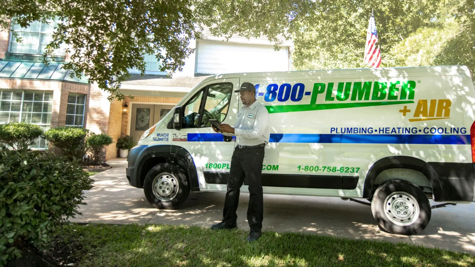 a man standing in front of plumbing van