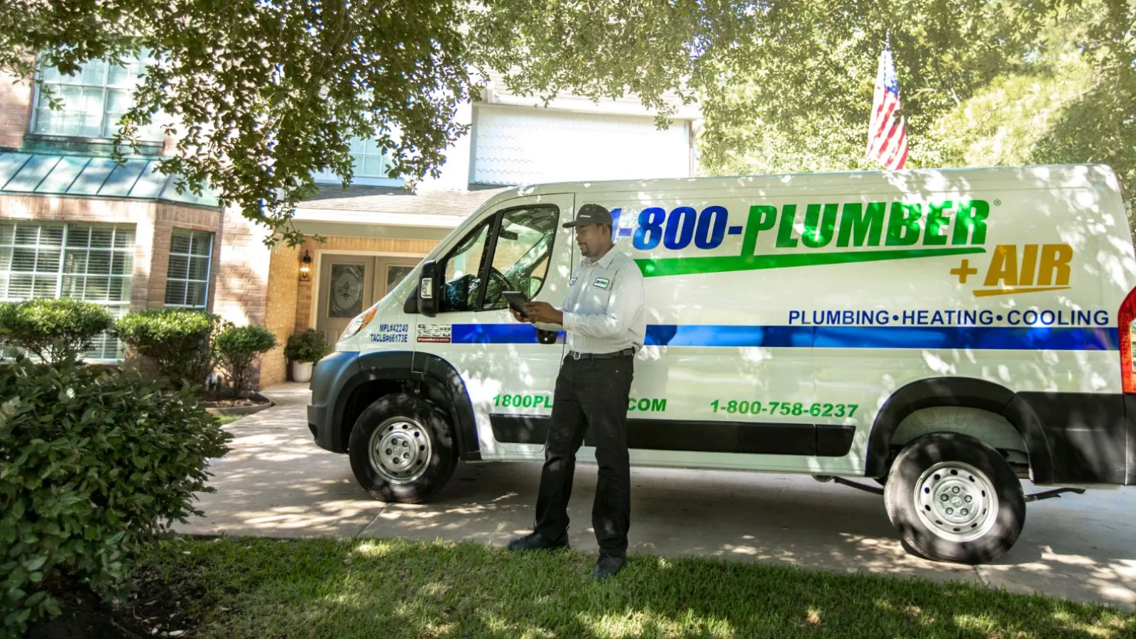 a man standing in front of plumbing van