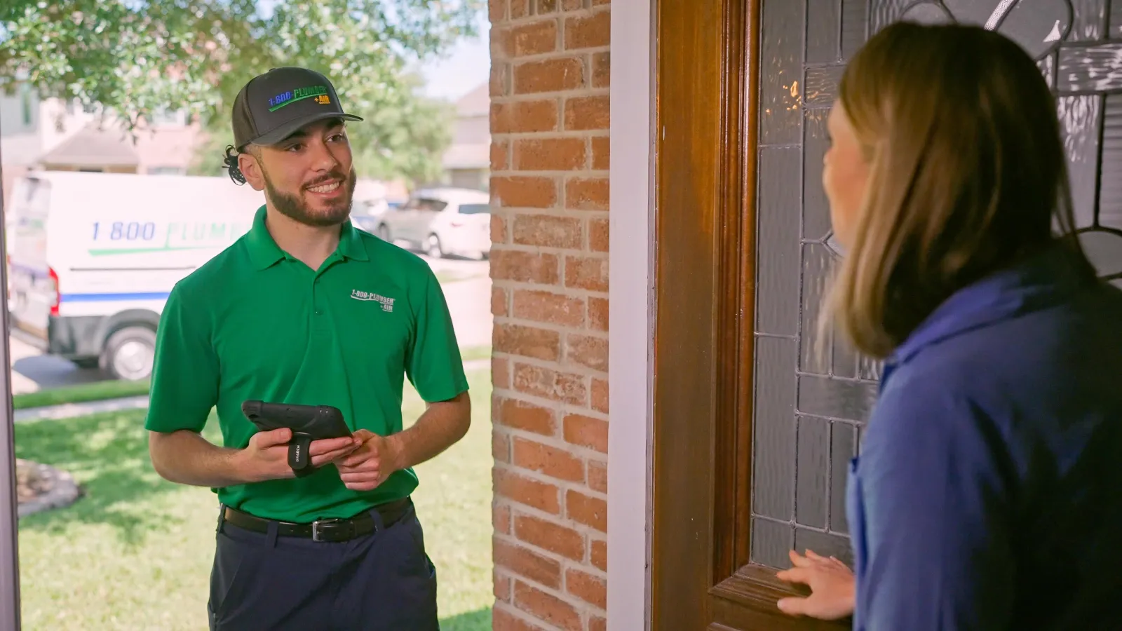 A Raleigh plumber greets a homeowner