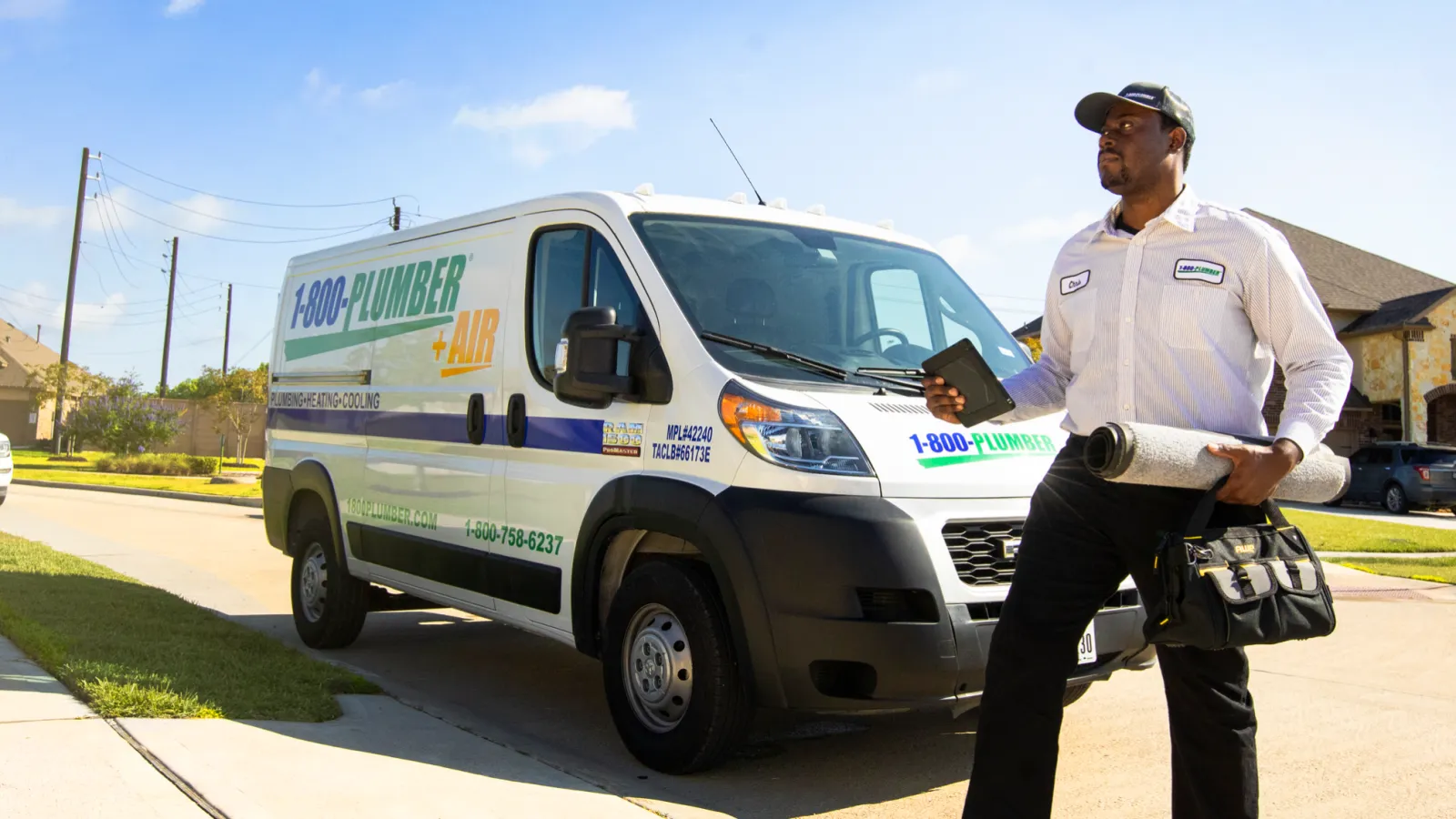 a man standing in front of plumbing van