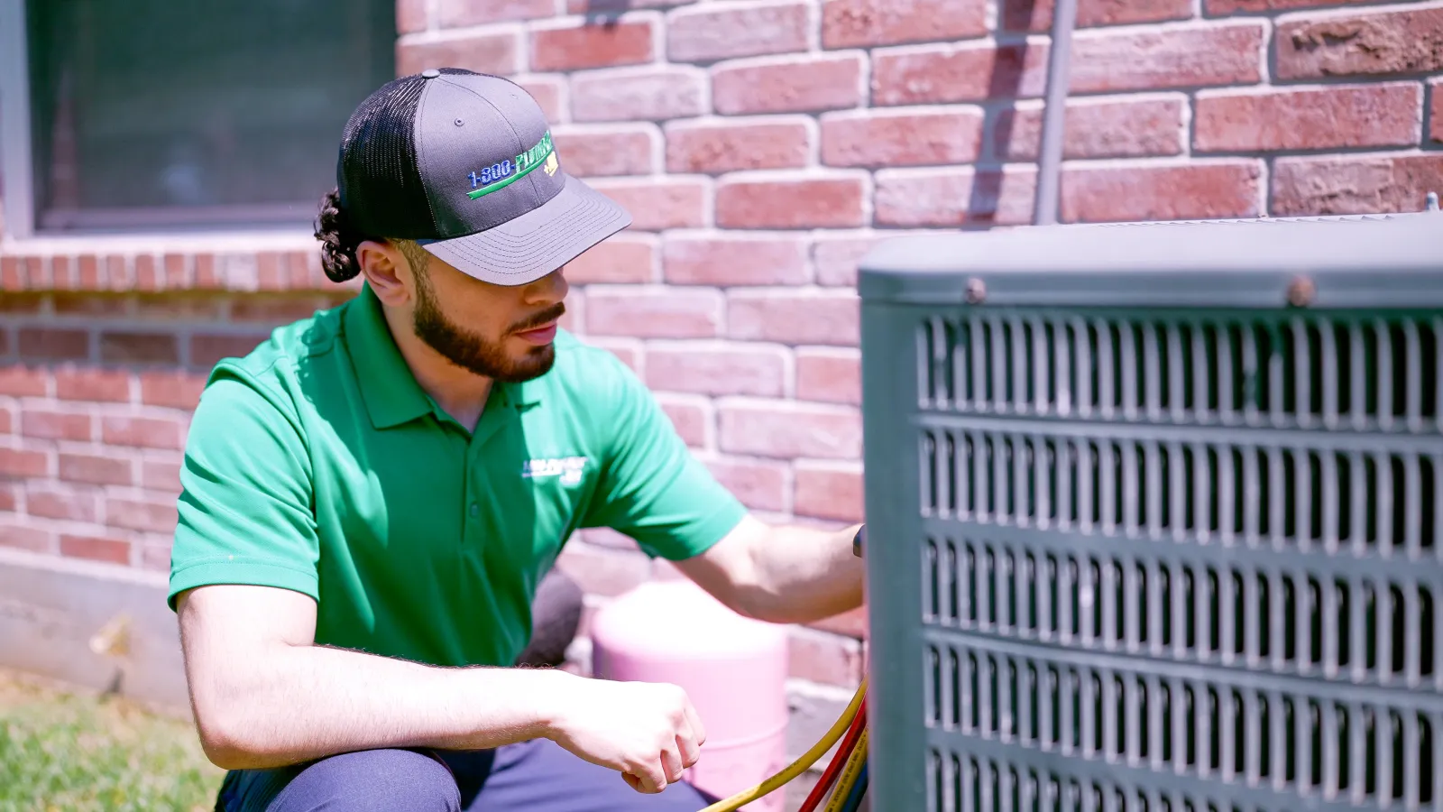 A Houston comercial heating technician repairing and outside heater