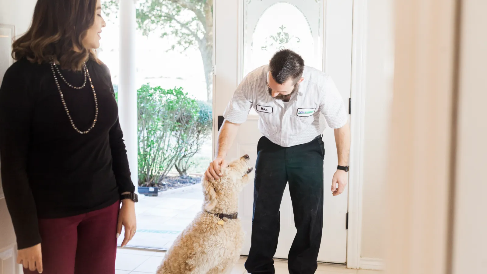 a man petting a dog