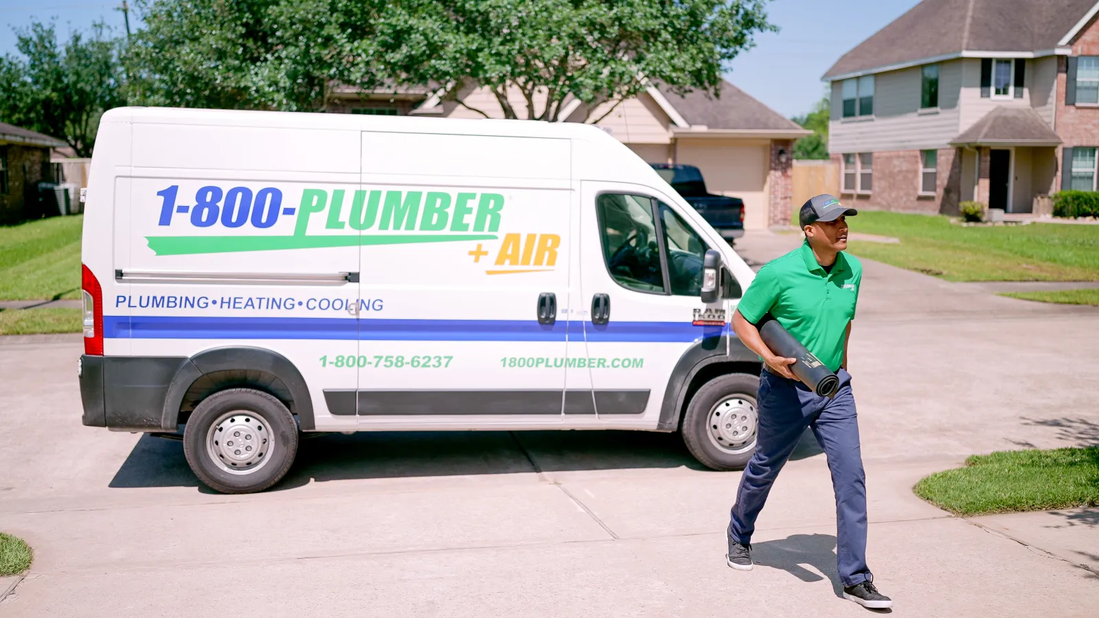 a man standing in front of plumbing van