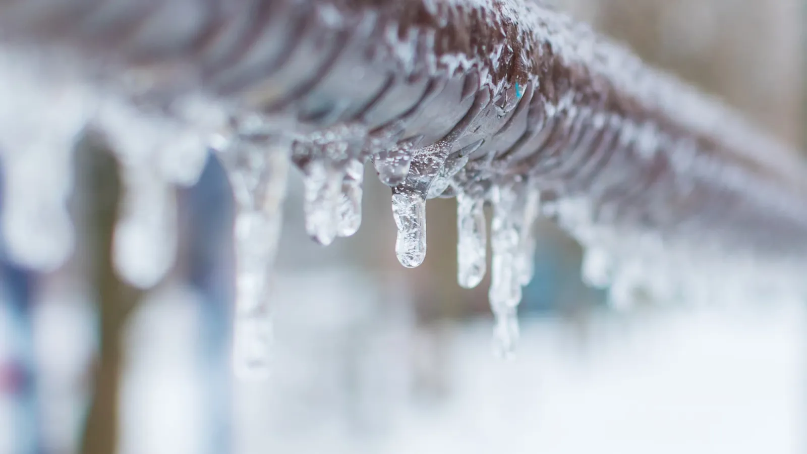 a close up image of a frozen water faucet