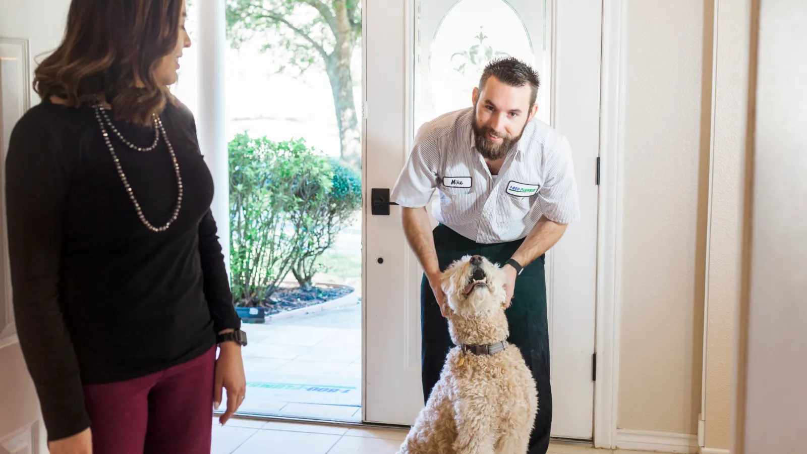 a man that is standing with a dog