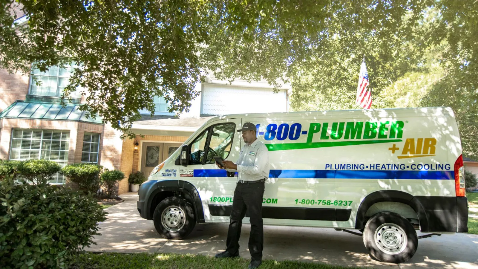 a man standing in front of plumbing van