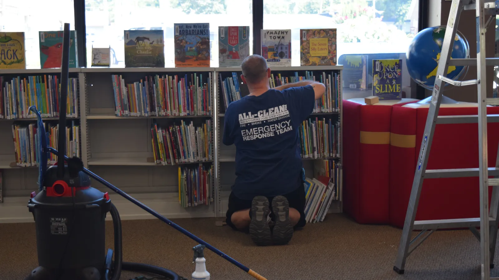 a person sitting in front of a book shelf
