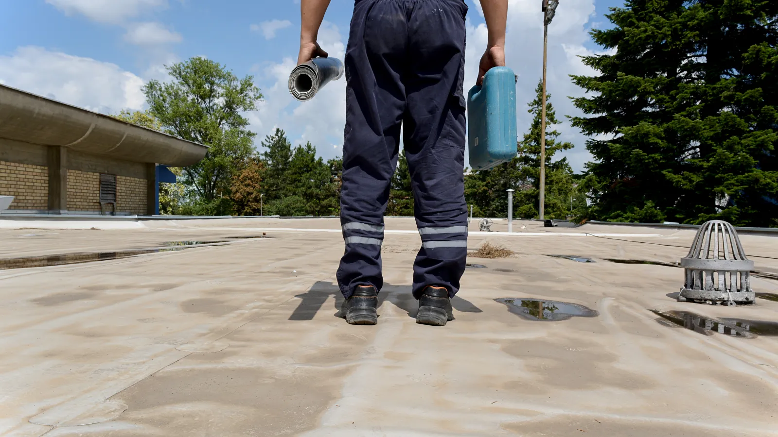 A roofing employee standing on a roof