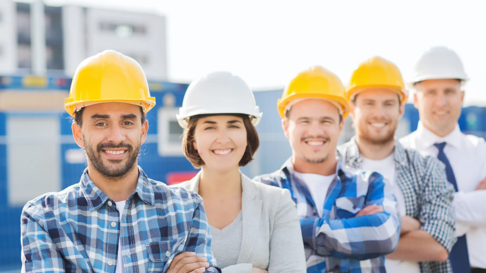 a group of people wearing hardhats and posing for a photo