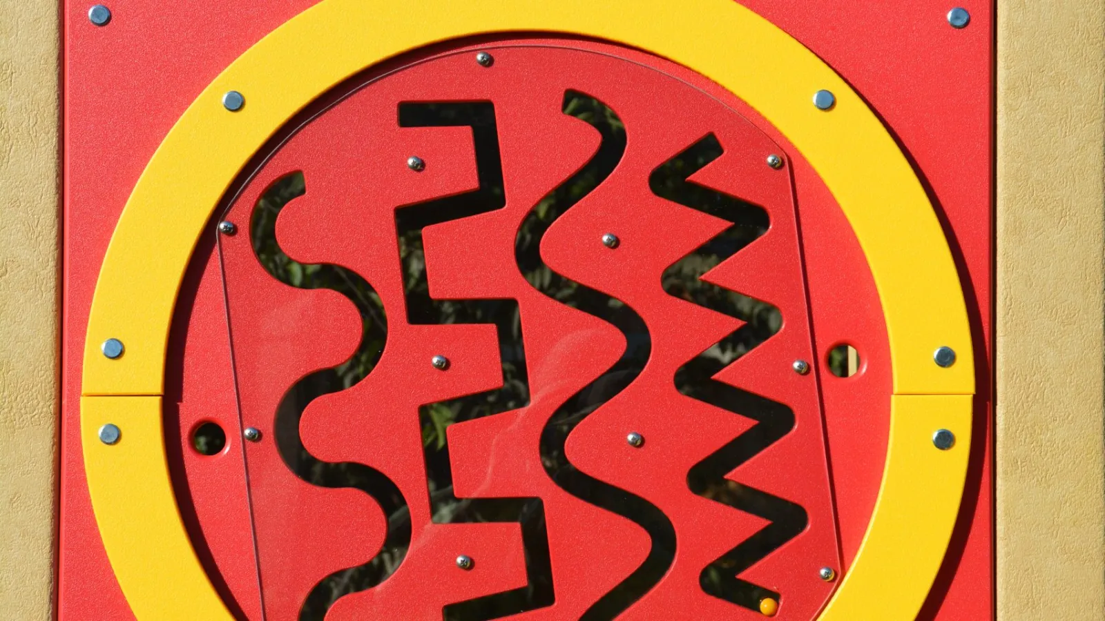 a sign with a red and yellow design