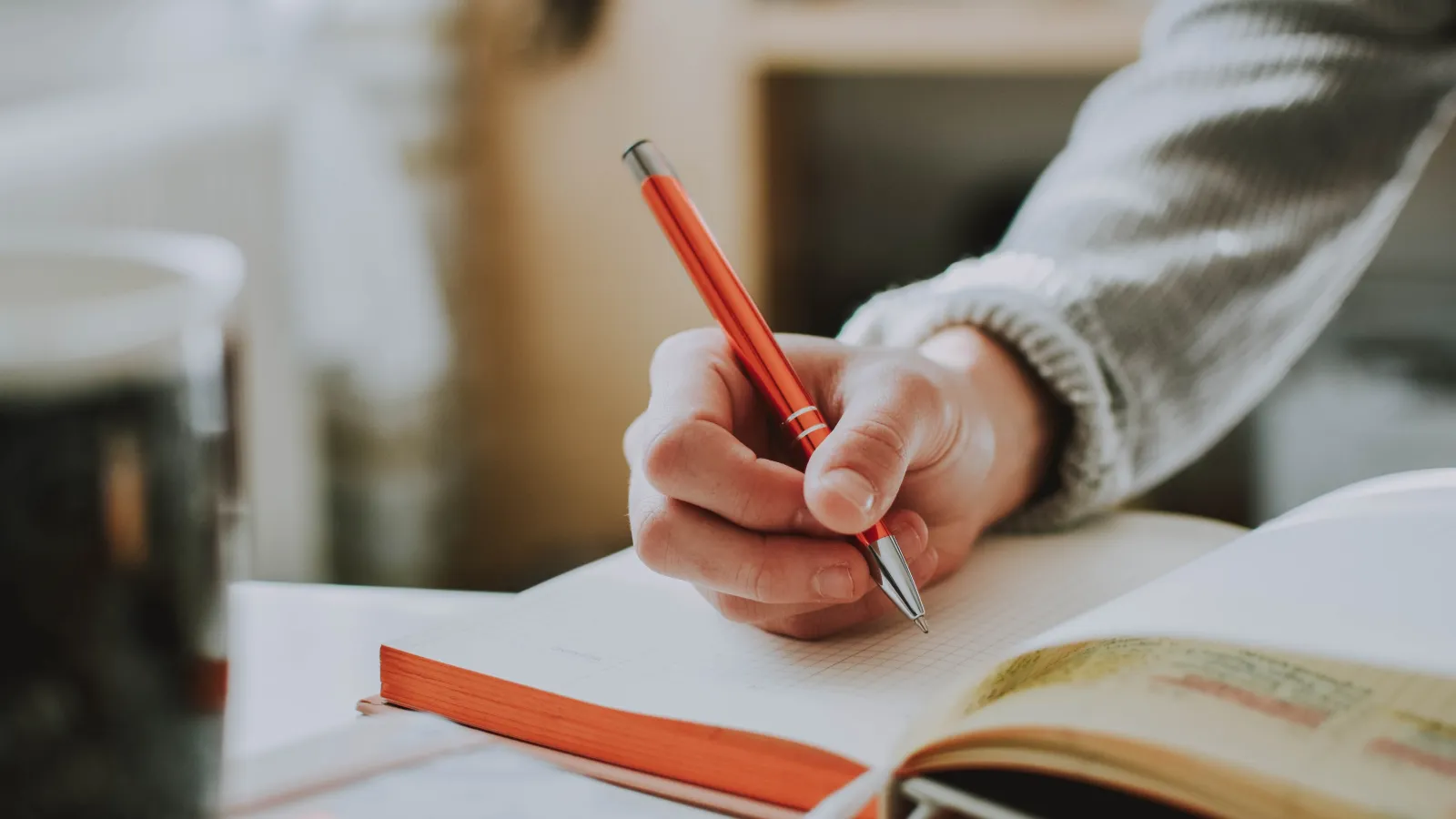 a person writing on a book