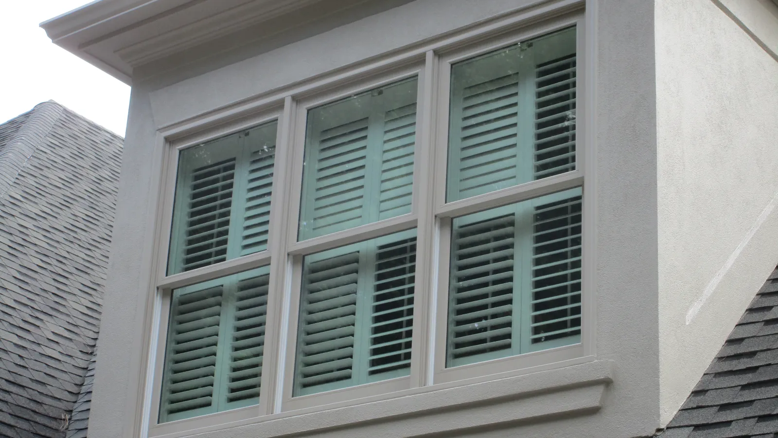 a white building with green shutters