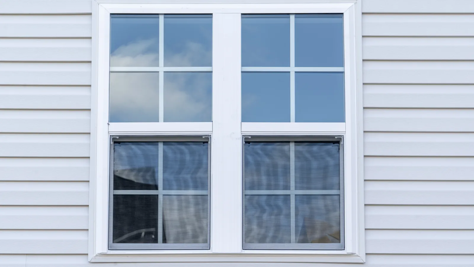 a window with white blinds