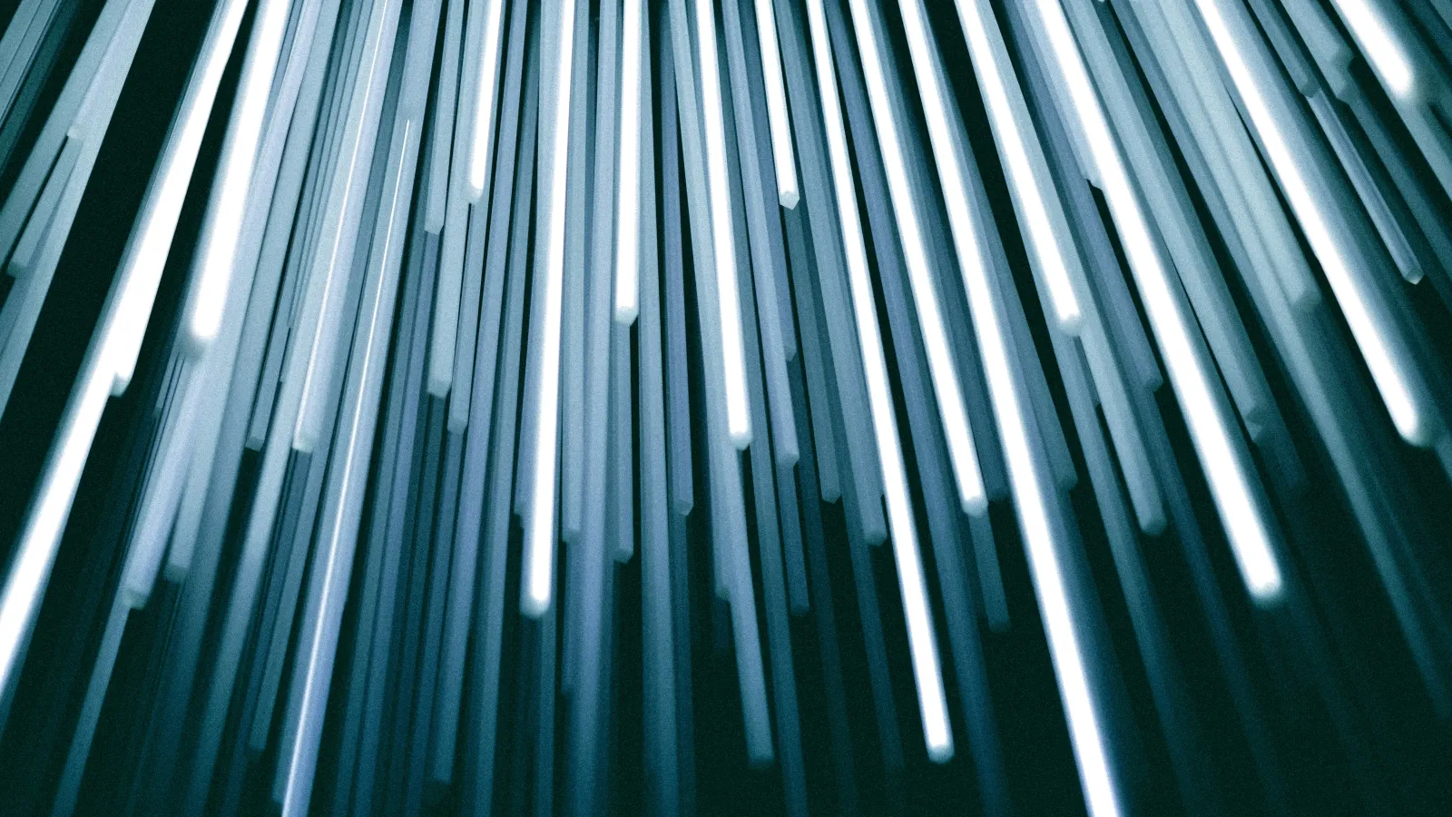 Vertical glowing white and blue light beams descending in a dark space creating a futuristic effect