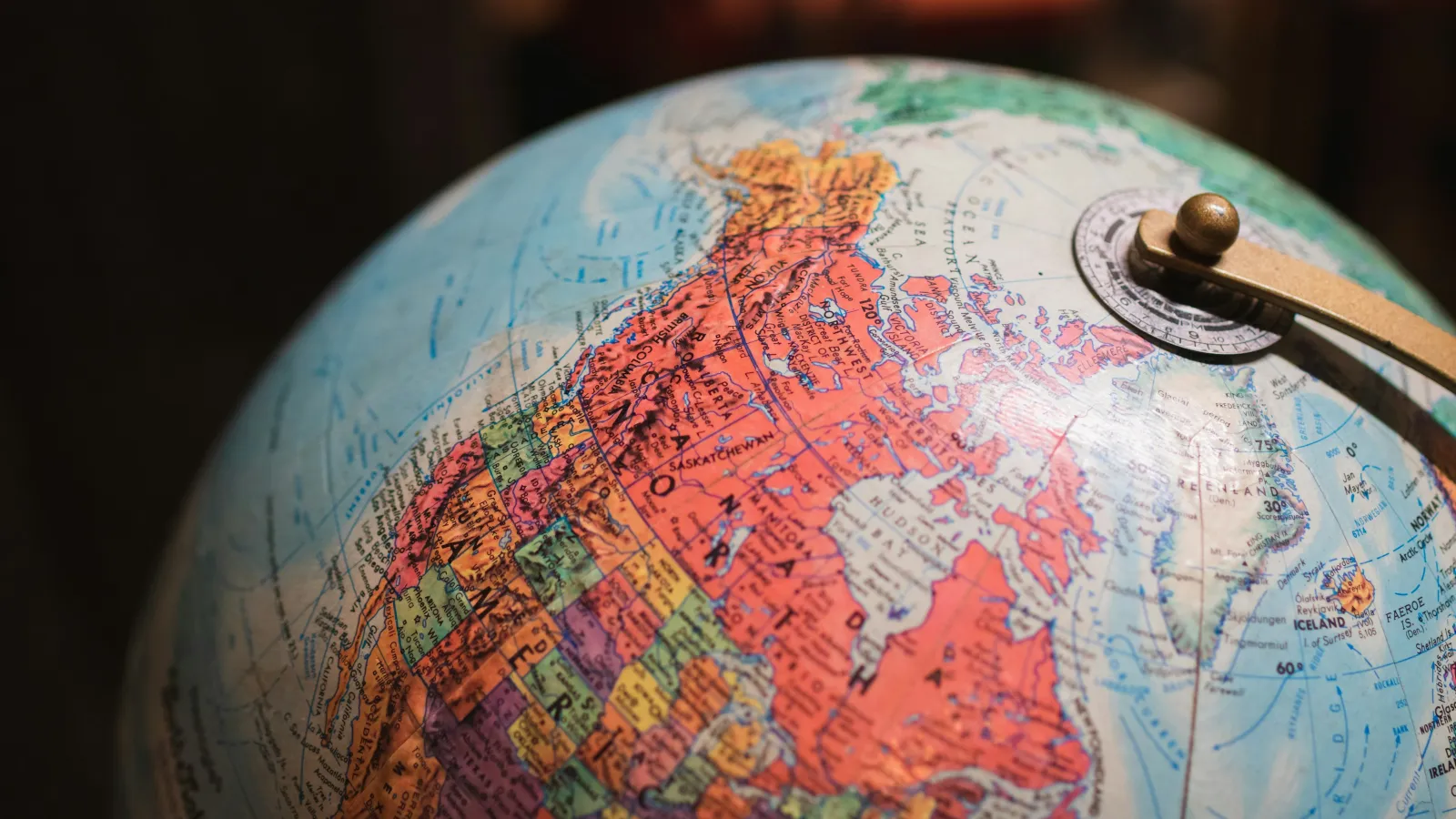 Close-up of a colorful globe showing detailed map of North America and the Arctic region with country borders.