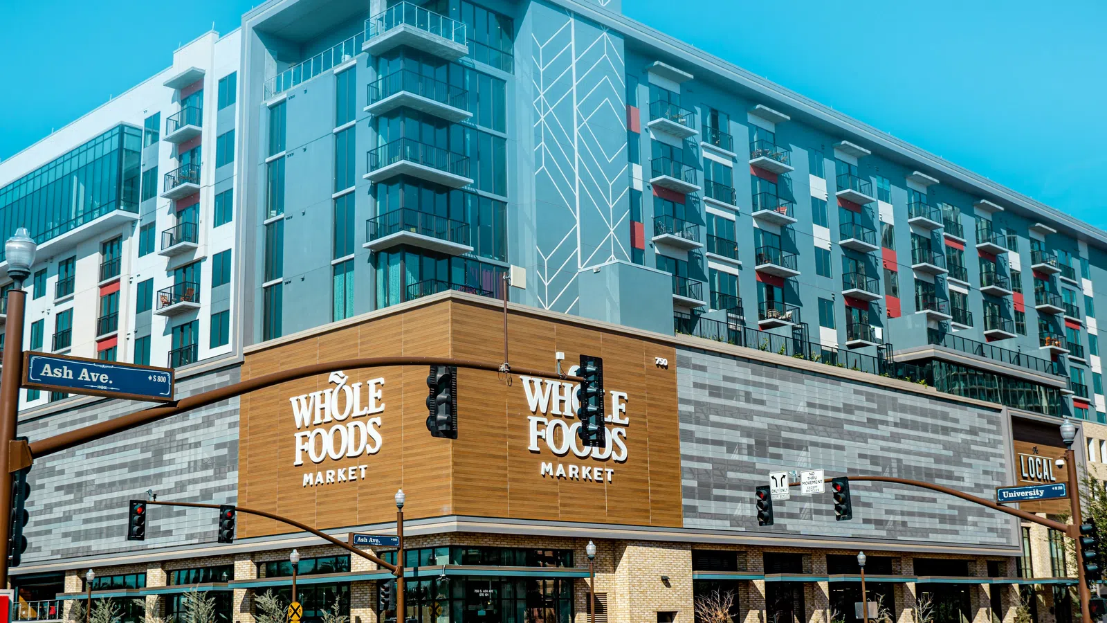 Whole Foods Market located in a modern mixed-use building at Ash Avenue and University intersection.