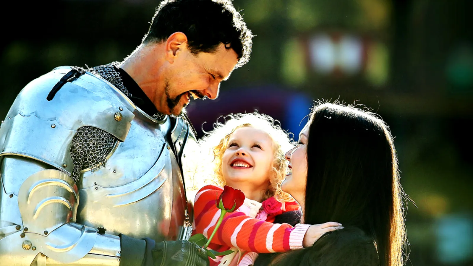 a man and a woman holding a child