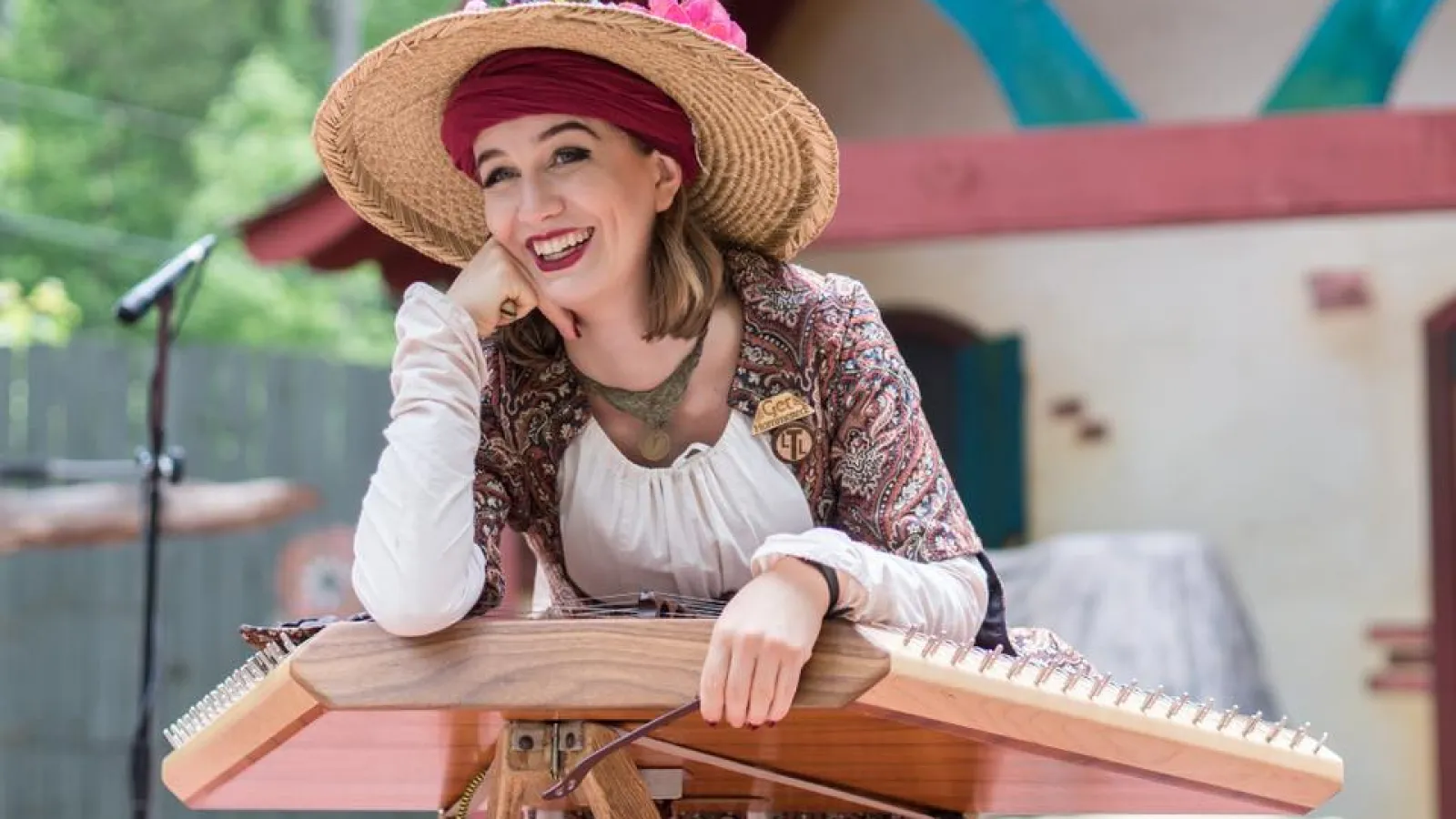 a person in a hat and dress standing at a table
