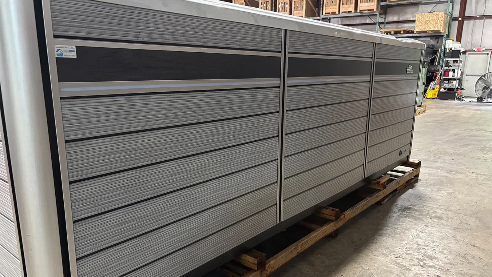 Large industrial metal storage unit with multiple horizontal drawers in a warehouse setting.