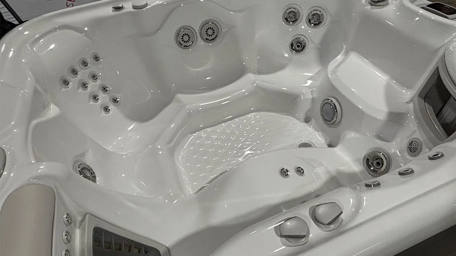 White luxury spa hot tub with multiple jets and ergonomic seating for relaxation and hydrotherapy