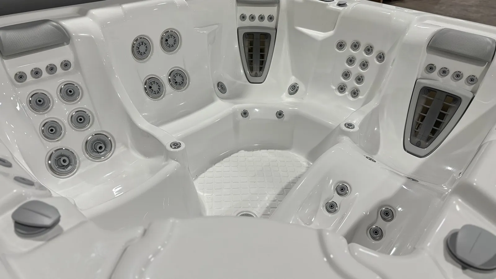 White luxury hot tub with multiple adjustable jets and ergonomic seating for relaxation and hydrotherapy.