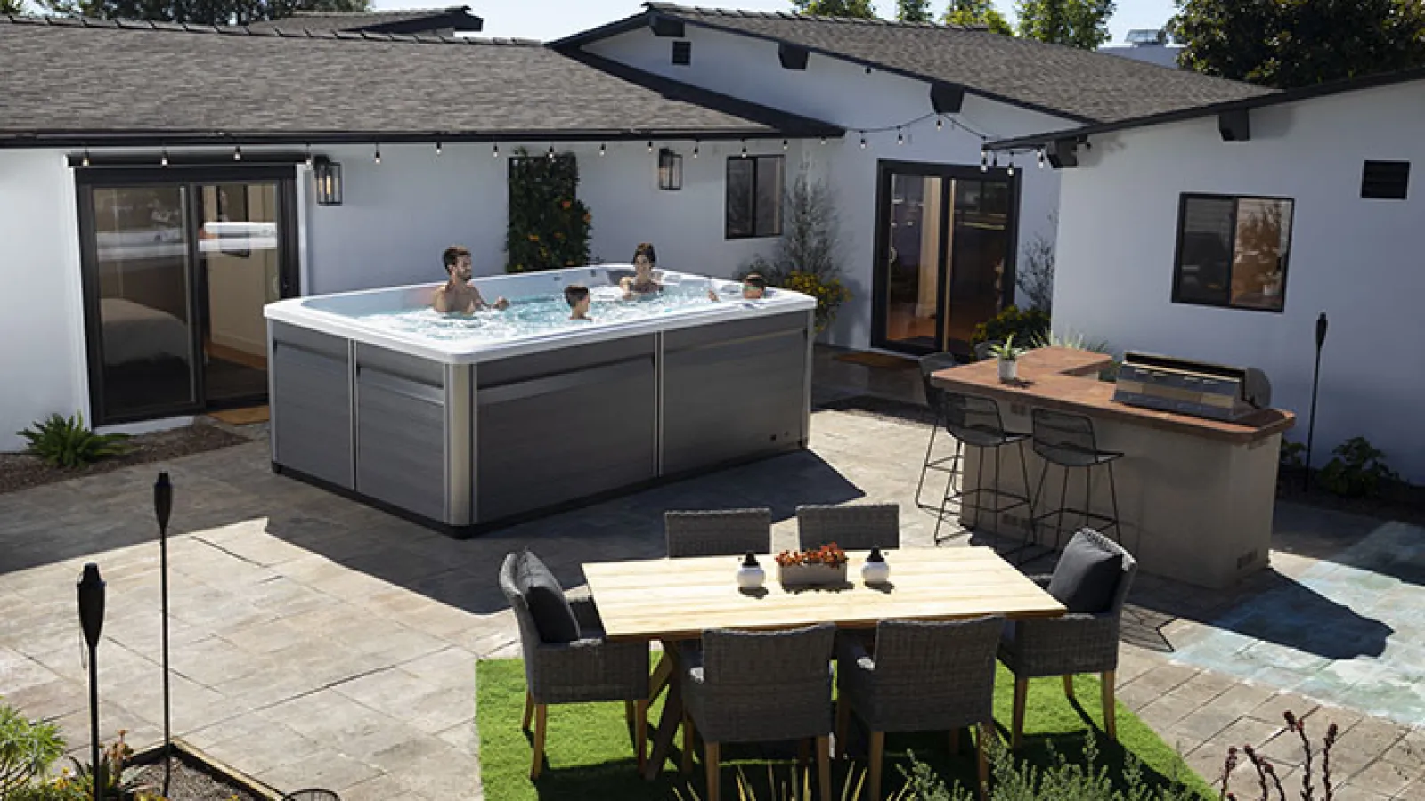 a backyard with a pool and a table and chairs