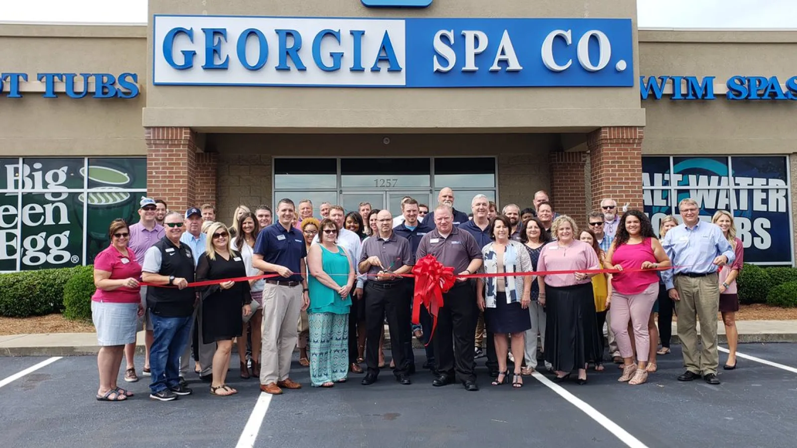 a group of people posing for a photo in front of a store