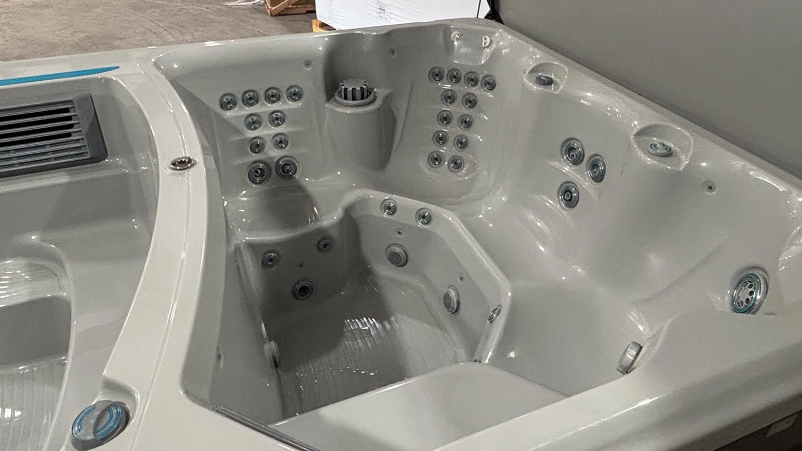 White luxury hot tub with multiple jets and contoured seating for relaxation in an indoor setting