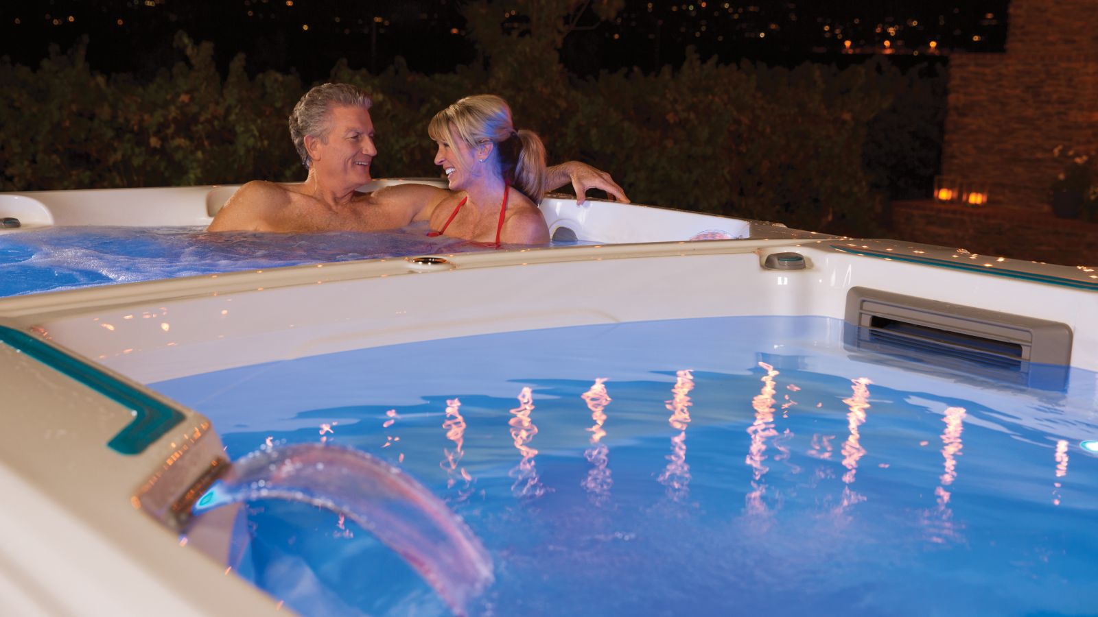 a man and a woman in a swim spa