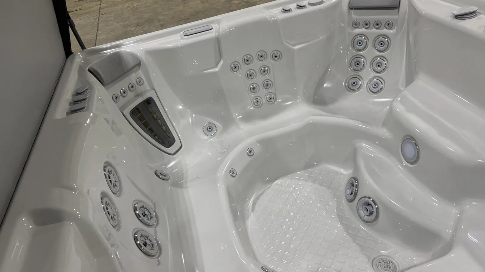 White luxury hot tub interior with multiple water jets and seating areas for relaxation and hydrotherapy.