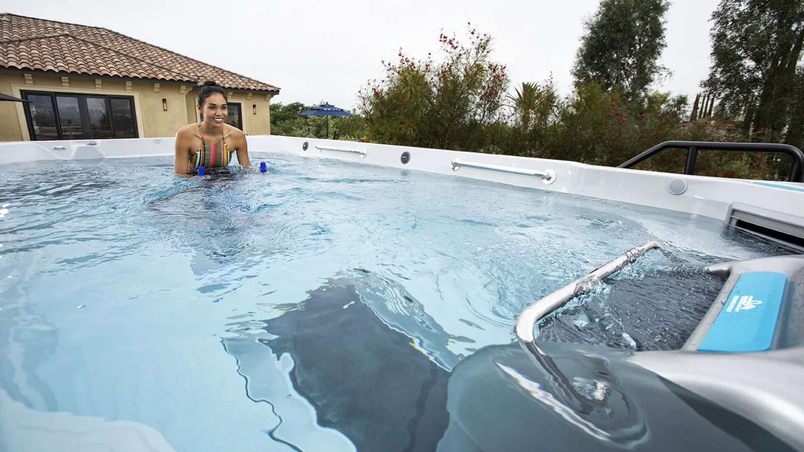 A woman on a bike in a swim spa