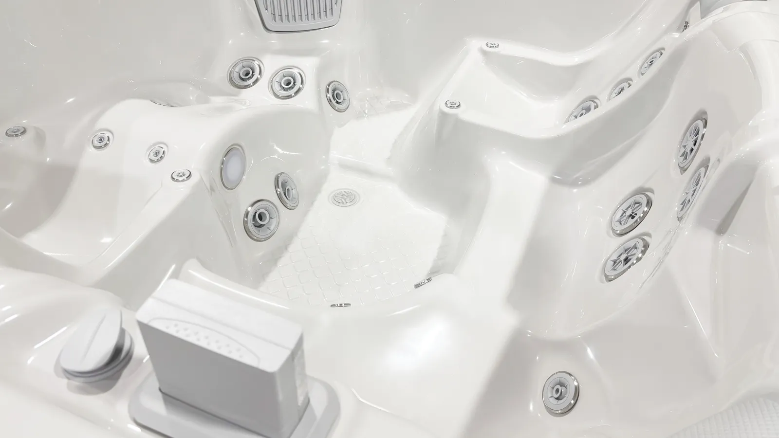 White empty hot tub with multiple water jets and ergonomic seating for relaxation and hydrotherapy.