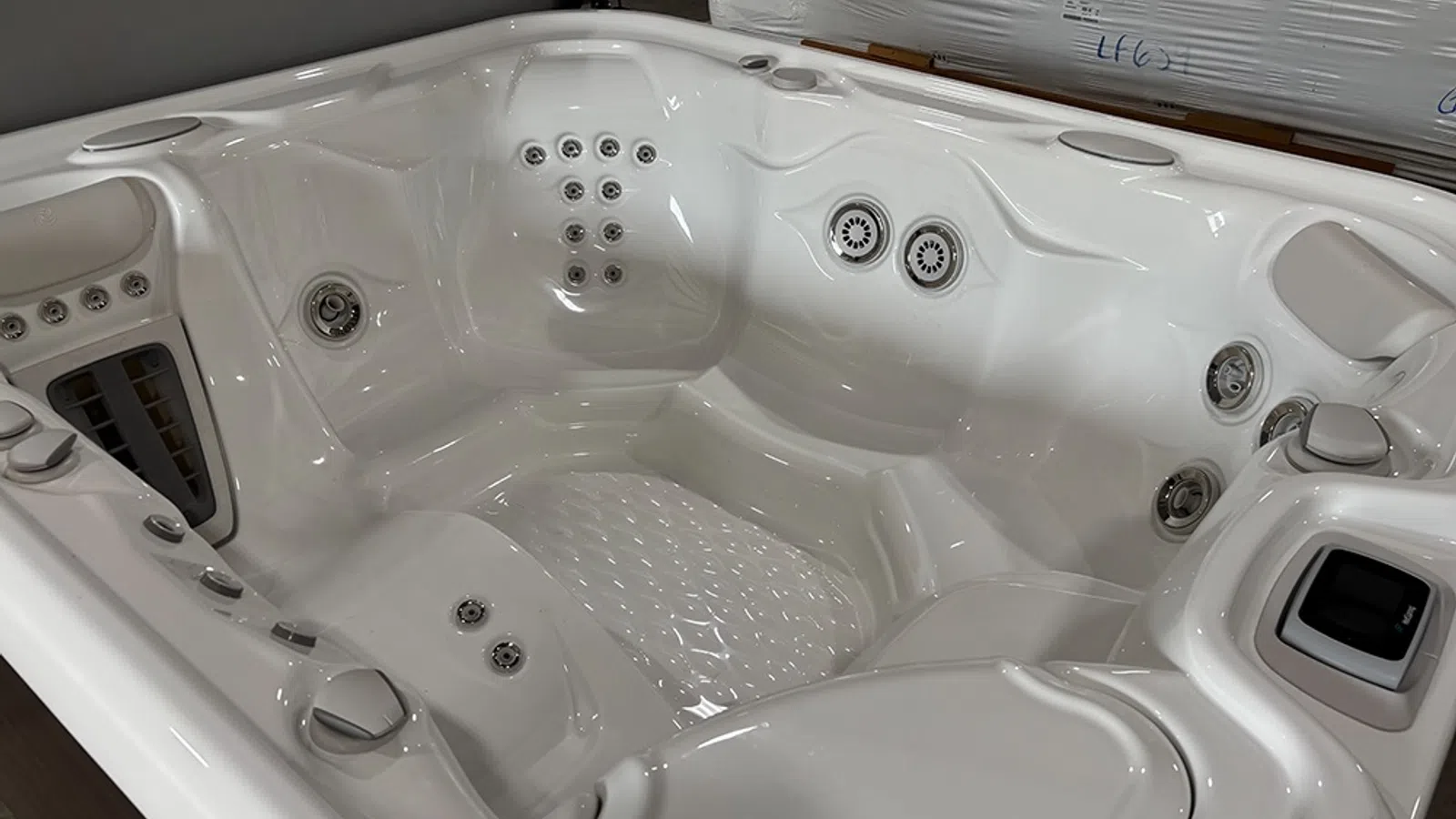 White luxury hot tub with multiple jets and ergonomic seating designed for relaxation and hydrotherapy.